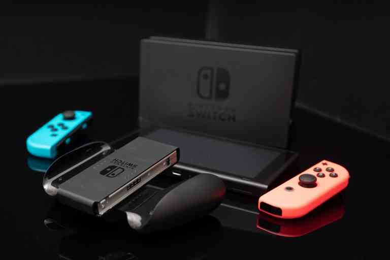 Nintendo Switch video game console developed by Nintendo, released on March 3, 2017 on a black background. Germany, Berlin - June 30, 2019: Nintendo Switch Joy-con controller on a white background